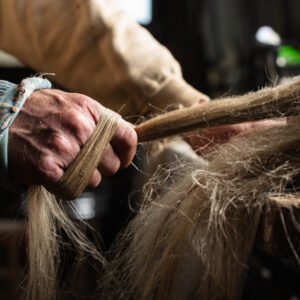 Hackling flax by hand. Photo: Yvette Monahan